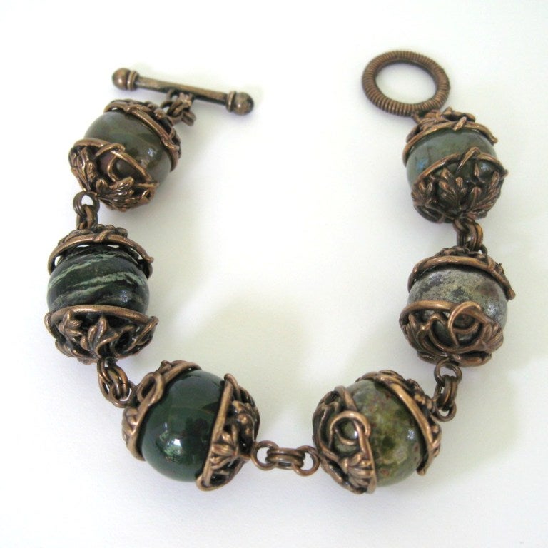 Fabulous 1990s Dweck Bracelet. There a total of 6 gemstones mounted in bronze tone over sterling silver, toggle clasp Hallmarked stephen dweck and Sterling silver inside the clasp. The bracelet measures 8 inches long with 20mm beads. Stephen Dweck