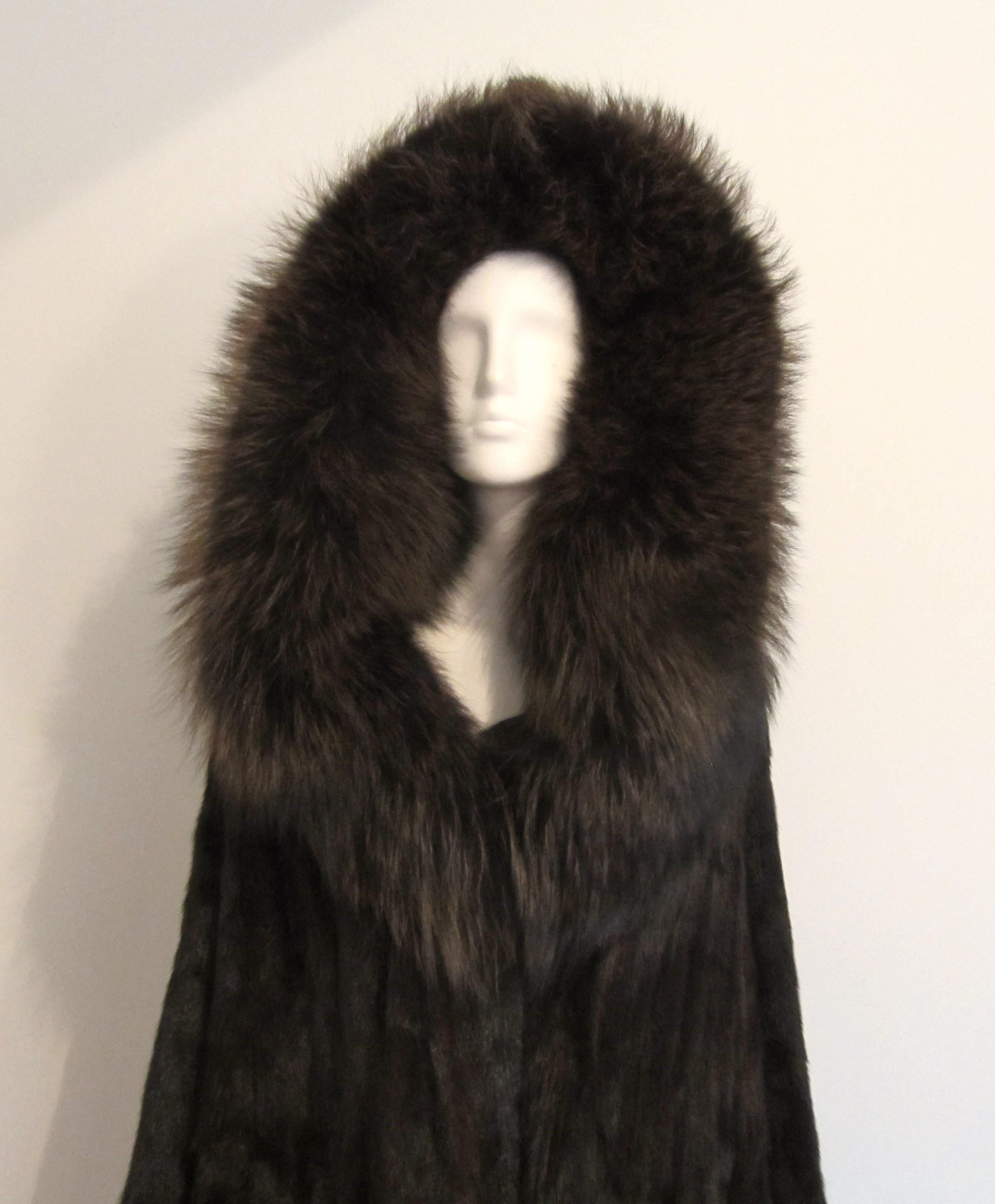 Fabulous deep dark Mink Jacket with Over sized Fox collar hood. This is a wonderful jacket. Soft and supple fur. 3 clip closure, 2 slit pockets, fully lined. Will fit a L - XL, but please refer to the measurements- up to 46in. bust- up to 50in.