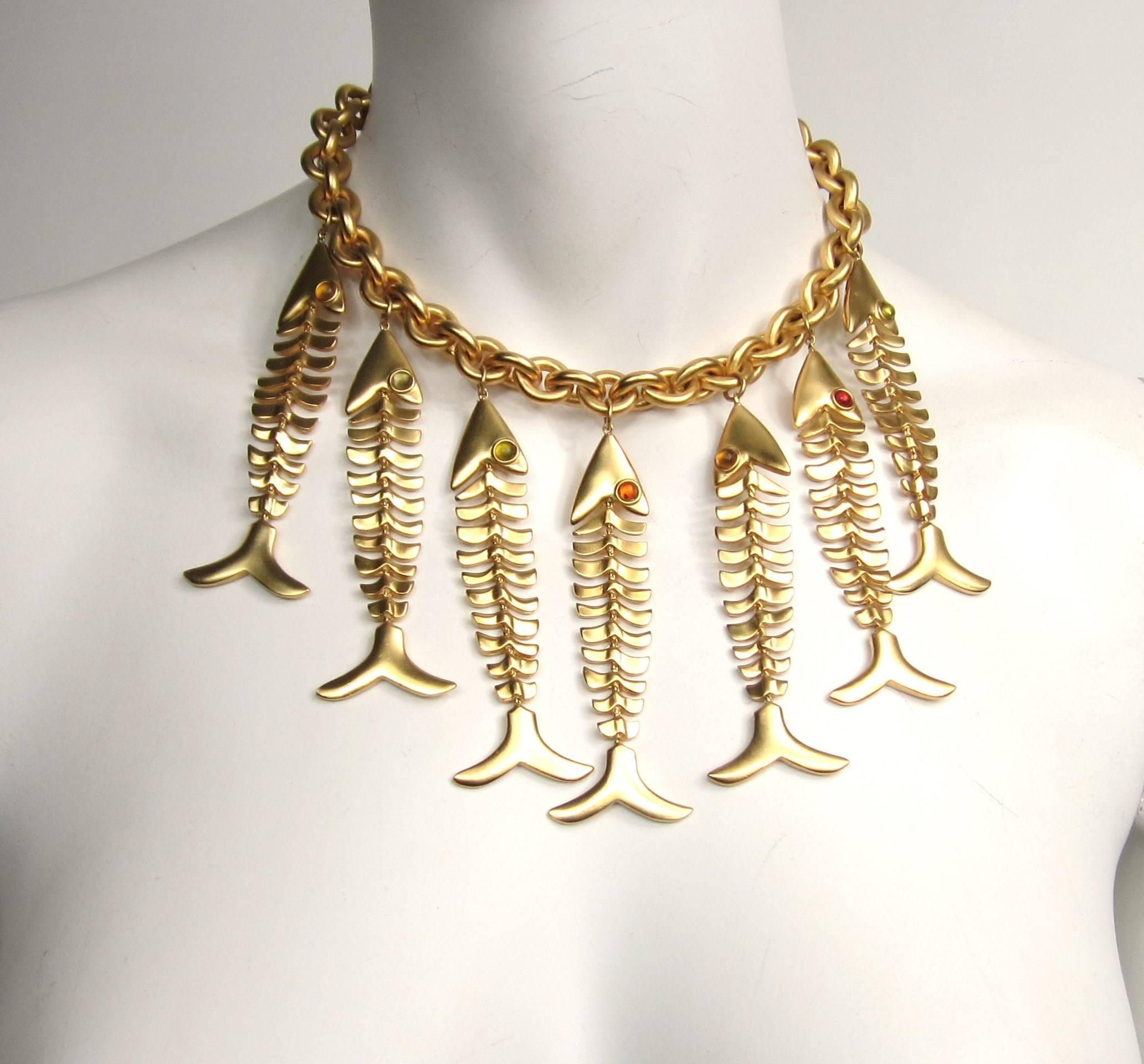 This is a amazing piece of vintage Anne Klein. 7 Articulated Fish hanging from a large gold tone chain. The fishes 3.32 inches long hanging from a 16 inch chain (end to end) Fish have bezel set stones as eyes. This is out of a massive collection of