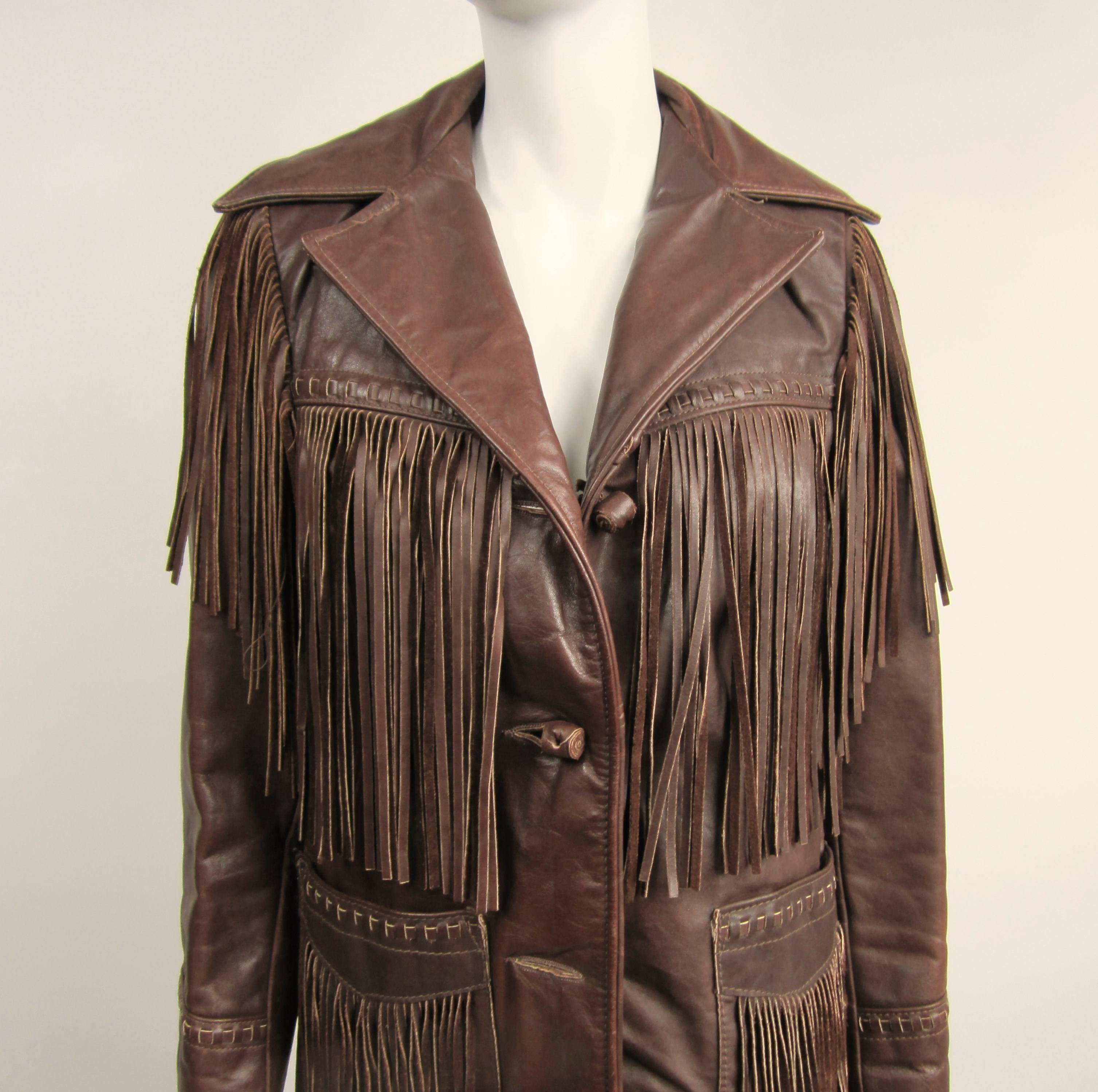   SCHOTT Leather Fringe Biker Jacket / Distressed. Dark Brown In color with Fringe all over this Vintage Leather Jacket. Pockets, Beast, Arm, Back all have fringe. Throw on a pair of Cowboy Boots and you are ready to go. 3 rolled leather buttons on