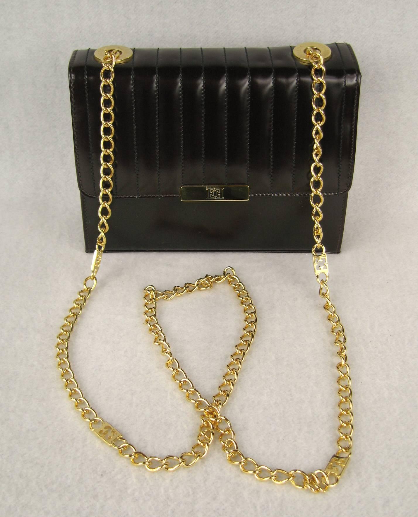 Kelly Brown Leather Ribbed Leather hand bag. Tags still in hand bag along with dust cover. Gold Tone link chain as shoulder strap. Zippered inside compartment. Gold Leather lining. Measures - 8 in. x 6 in.  x 3 in. deep - 24 in.  long chain strap.
