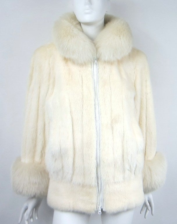 Stunning Mink with Fox Trim on collar and Cuffs from Christian Dior. This one has vertical pelts with a wide horizontal Strip around the bottom of the jacket. Luxurious Fox collar and cuffs.One small feature that is a wonderful addition is the