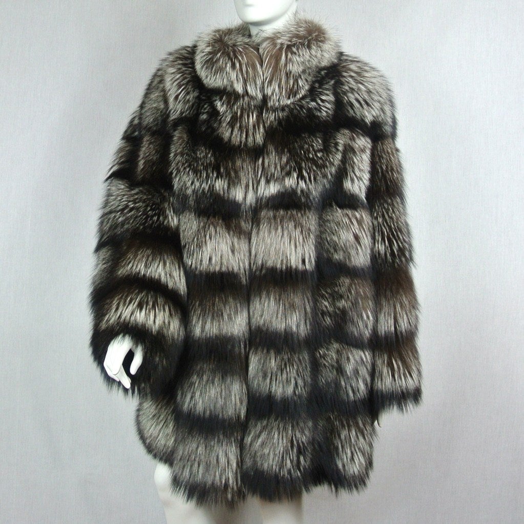 Silver Fox Coat from Famed design house Escada. Pictures don't do this any justice! It is an oversized coat, plush, soft and so cozy. This will turn heads when you walk by! A Stunning coat, that will not disappoint. Glam with snake print lining. It