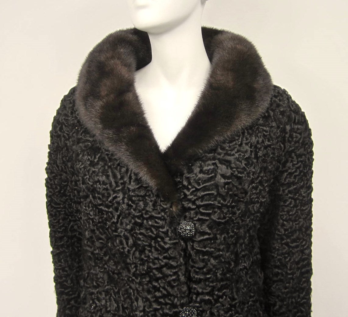 Simply stunning in person--Black Persian Lamb Jacket. Side slits and a 3 buttons closure--- Mink collar --- Fab 1960s Jacket. Fur is soft and supple 
Measures Chest up 44 inches --- Waist up 46 inches --- hips up 48 inches --- Length 36.75 inches