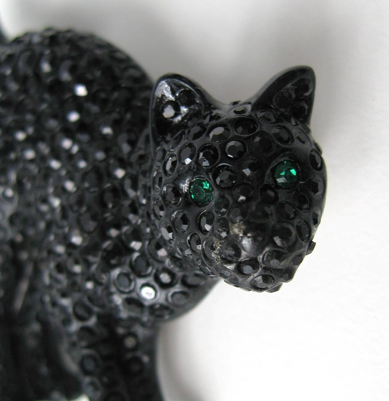 Green eyed Black cat with Black swarovski crystals make up entire body, with stunning green eyes. Measures 2.32 in x 2.00 in. Again, purchased and stored away, never worn. This is out of a massive collection of Hopi, Zuni, Navajo, Southwestern,