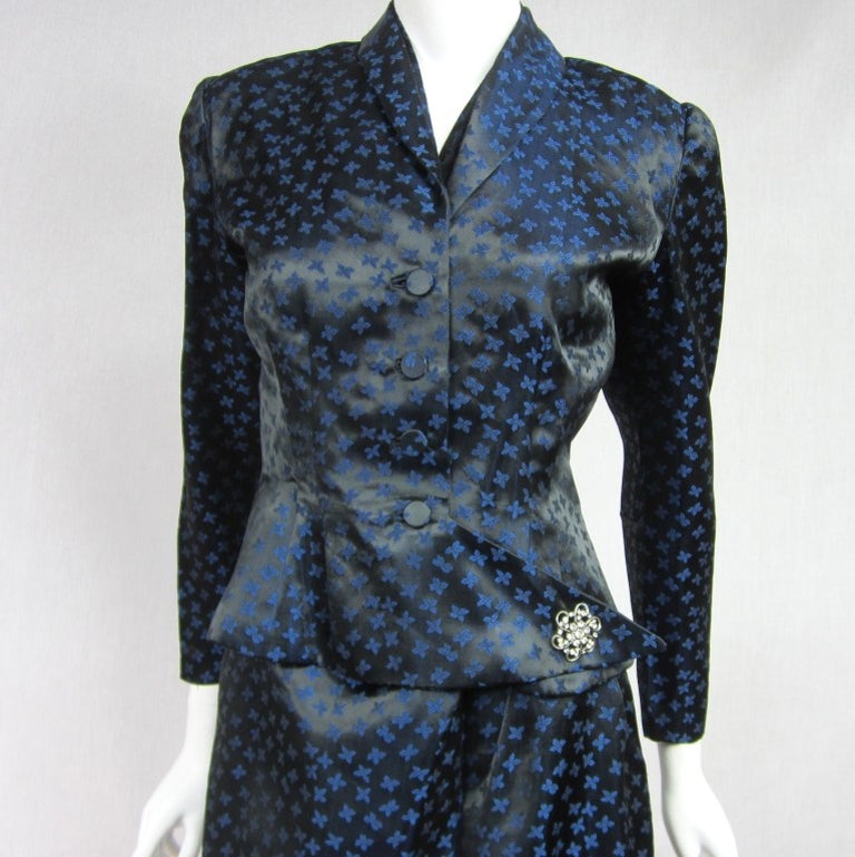 1940s early 50's Halter Dress with Matching Jacket. Covered buttons  side snap Closure. Shoulder Pads. Side Zipper working great. Has Original Belt
Added Brooch on the Jacket. Great lines on the skirt. Shirred Side hips  on the dress This is a