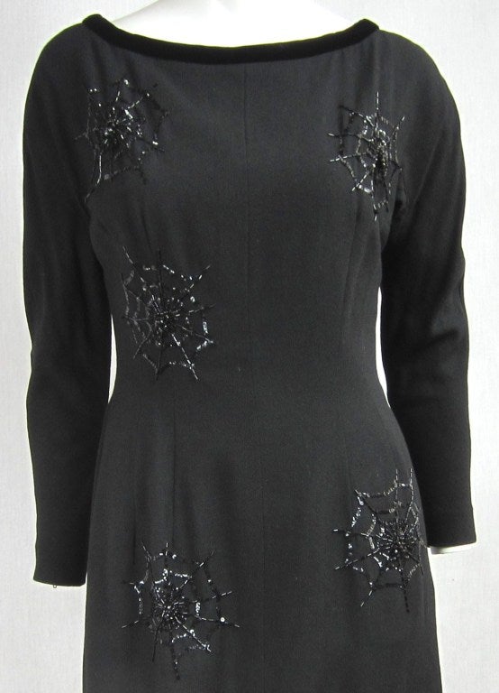 Sexy, Sexy. 1960s Black Dress. This is so cool!. Covered in Spiderwebs made up of sequins and beading  *Black Widow Dress. Velvet trim around neckline and Bow at the back of dress with Zippered cuffs. Zippers up the back, and snaps shut. Deep V