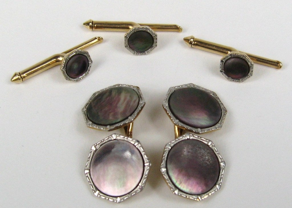 Shimmering in color is this set of Cuff links and Studs.  You have double-sided cuff links and three shirt studs or vest button 5 pieces in total. Stunners from the 1930s .54 in diameter cuff link .24 in diameter on studs. This is out of a massive