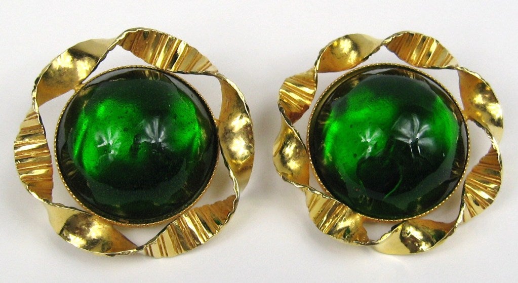 Stunning Large green glass Cab's make up this clip on earrings. A gold plated ribbon surrounds the glass. Made in France 
Philippe Ferrandis is an internationally renowned, French jewelry designer with over 25 years of dedicated work in his chosen