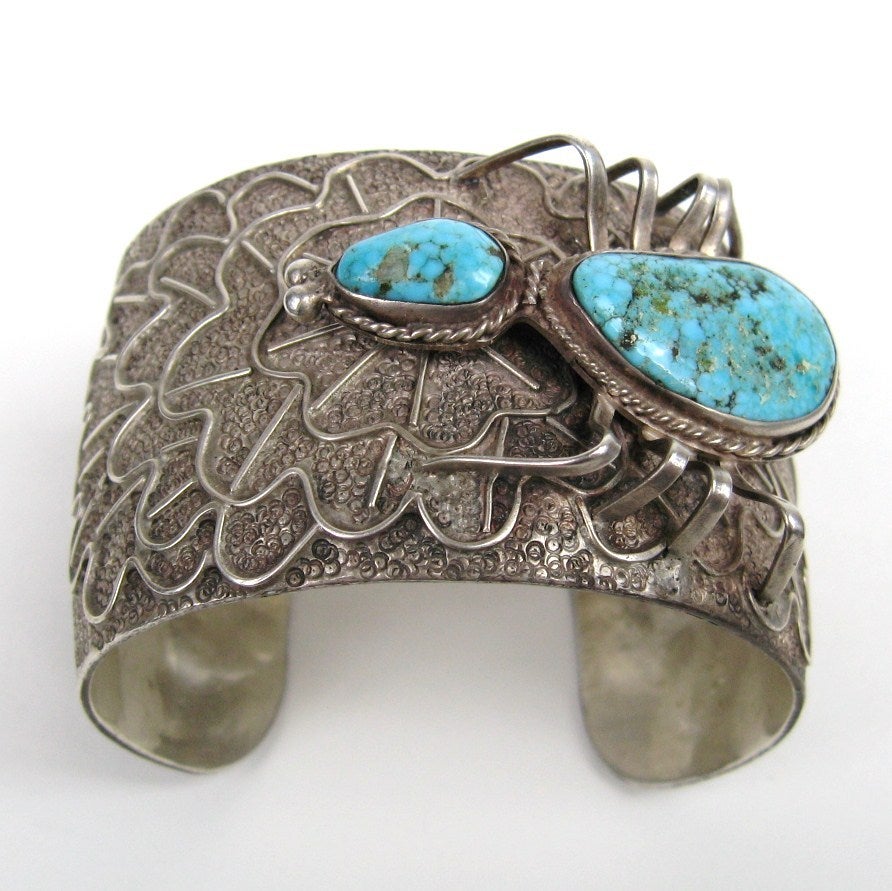 Spider is weaving a web on your cuff! Navajo Turquoise Sterling Silver Spider Web Cuff Bracelet. Large Turquoise Stone. This is a stunning piece of Native American Jewelry. It measures 1.8in wide- Spider is 1.9 inches. Cuff does adjust a bit in size