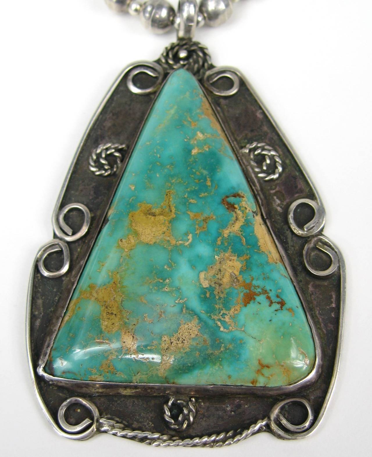 Large hachita turquoise set in a handmade sterling pendant. Measures 3.35 inches  x 2.15 inches - Chain measures 28 inches - total drops to 34.5 inches 
Hallmarked hand scripted on the back. This is out of a massive collection of Hopi, Zuni, Navajo,