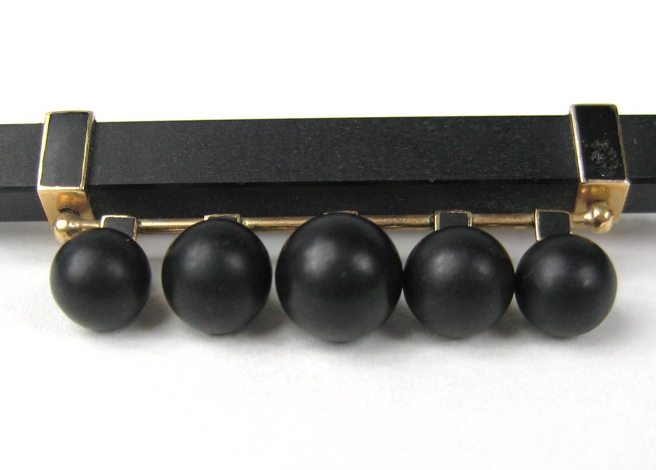 A Victorian Jet mourning bar pin with 5 hanging jet balls hanging from a 14K gold bar. Acquired from the Museum of the City of New York. It measures 2.3