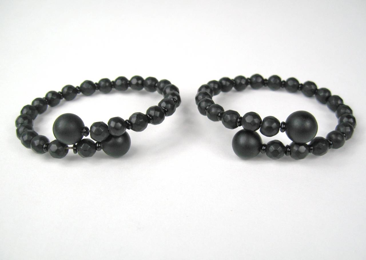 Stunning pair of matching faceted Whitby Jet Jet Bracelets, Acquired from the Museum of the City of New York. In Excellent condition. Beads measure 12mm down to 7mm. They wrap around  your wrist. What a find that there is a pair! This is out of a