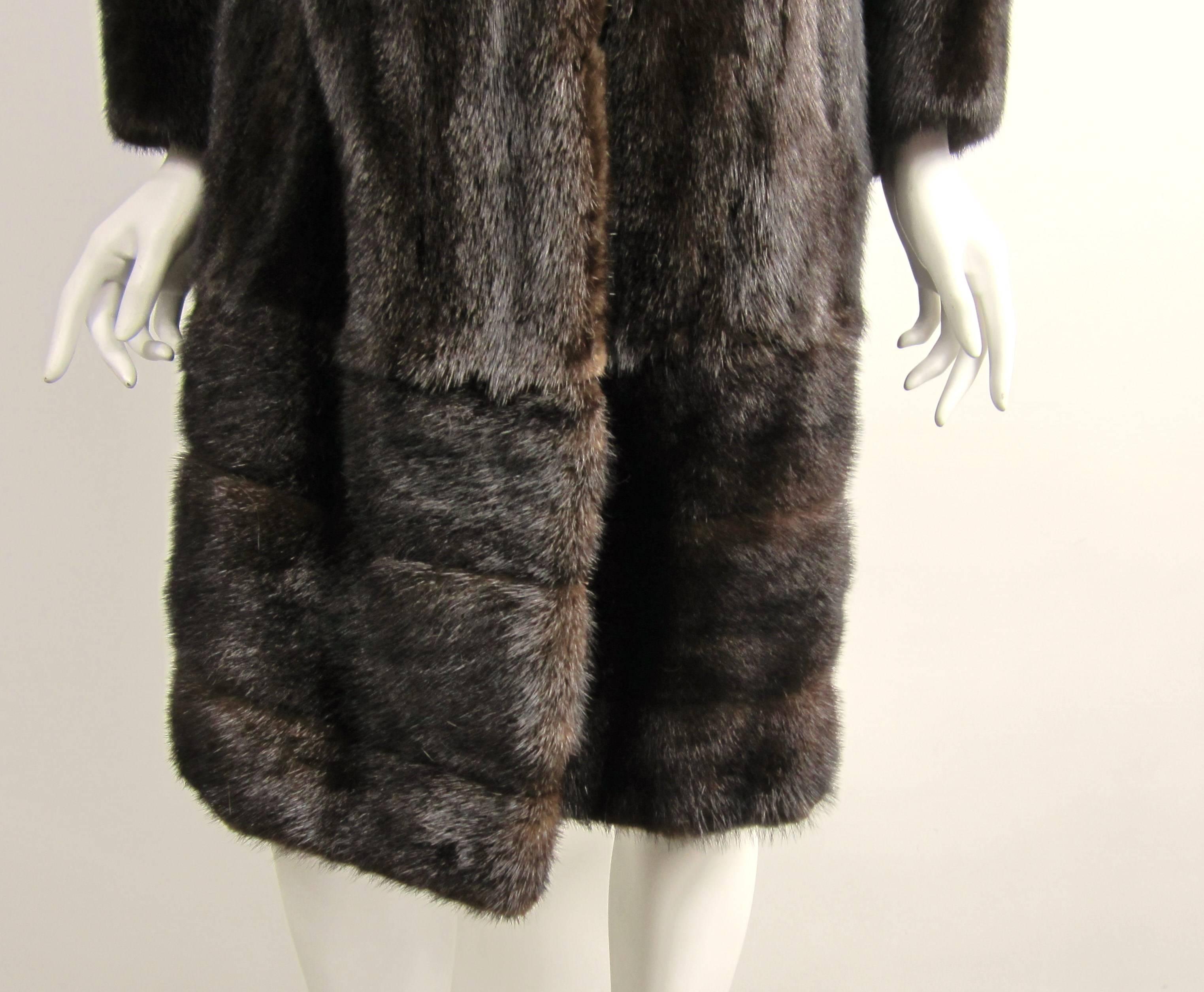 Two coats in one, this is a coat which the bottom zippers off to become a Jacket.  Vertical and Horizontal pelts. Mink is soft and supple - Button closure. Measuring approximately Up to 42 in. Bust.. Up to 42 in. Waist - Up to 46 in. Hips - Length