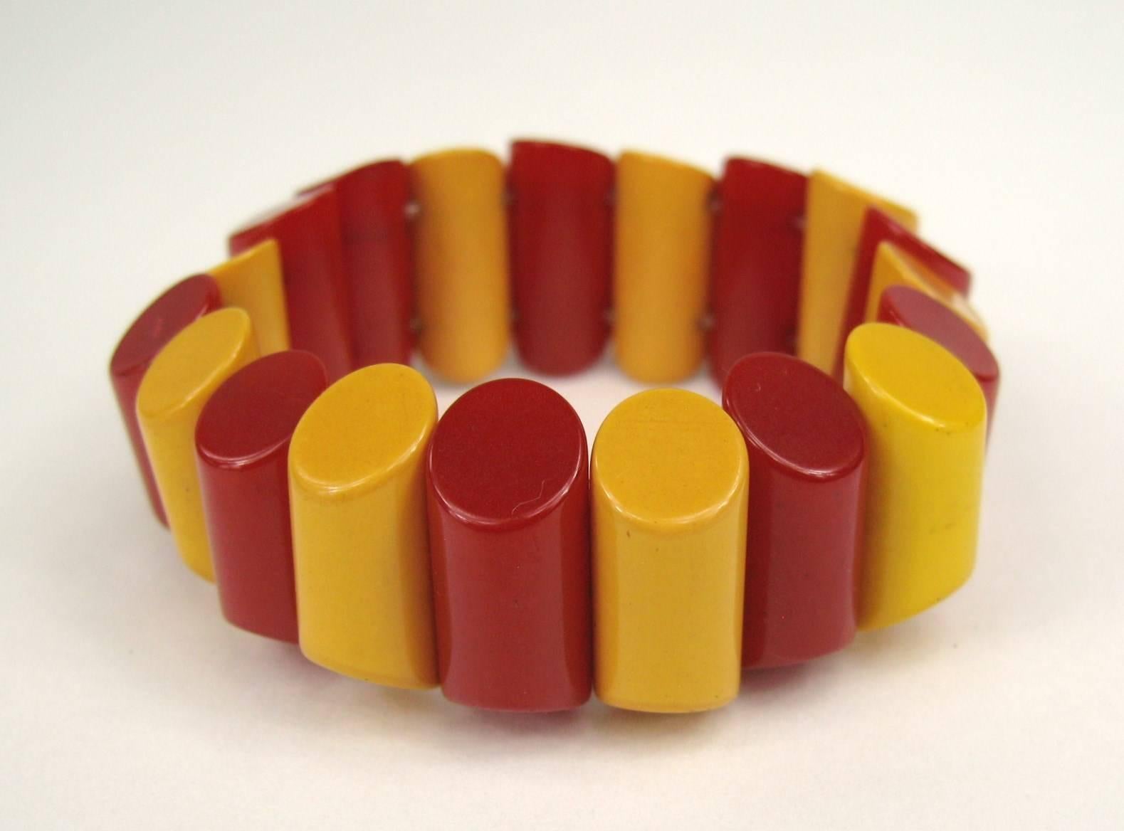 A fun vintage Bakelite / Catalin stretch bracelet in a rich butterscotch and Cherry. The bracelet is made up of narrow strips of Bakelite strung on heavy elastic. The thin panels have rounded edges, the top and bottom edges are angled down, the