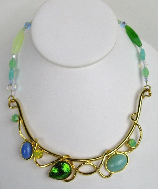 Ferrandis Pastel glass Cabochons set in a gold plated necklace. This piece is from the start of his career in the late 80s early 90s. Has wonderful greens and blues glass, some yellows and some faceted crystals. It is approx. 15 inches  long and can