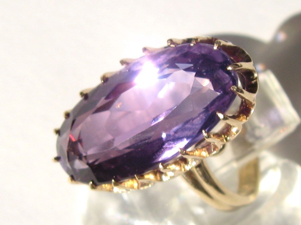 Oval Cut Faceted 7 1/2 Carat Amethyst Stone sits high in a Basket Claw setting and looks to be hand made, Looks Early. Presentation on this is spectacular. 14k Gold Hallmarked with a star, acid tested. Ring is a size 5 and can be sized up or down.
