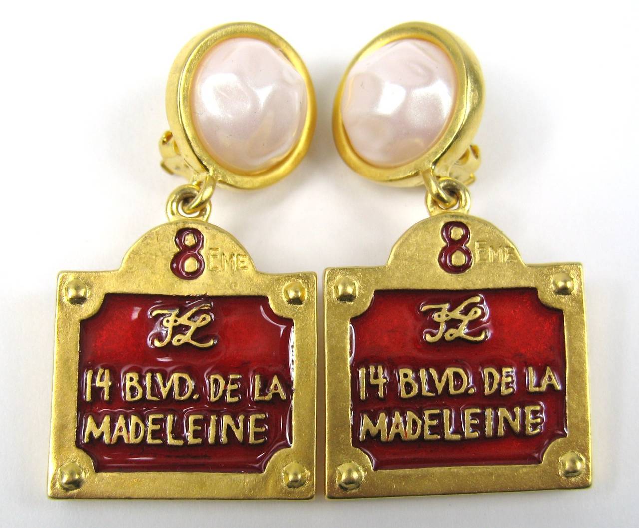 Karl Lagerfeld Gilt metal with Red Enamel with the words 14 Blvd De La Madeleine. Still on original  earring holder, the client never wore these, they measure 2 in long x .77 in at your earlobe. This is out of our massive collection of Hopi, Zuni,