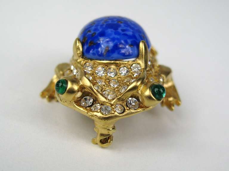 A signed Kenneth Jay Lane KJL , gold Gilt Swarovski crystal. lapis blue art glass cabochon. This striking figural piece is unique, a magnificent color, unworn and measures 1.67 x 1.30. This is out of a massive collection of Hopi, Zuni, Navajo,