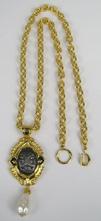Stunning Gold gilt Chain with Baroque pearl front and center. Double FF on the pendant. Measuring 30 inches long on the chain with an additional 4 inches on the pendant. This is out of our massive collection of Hopi, Zuni, Navajo, Southwestern,