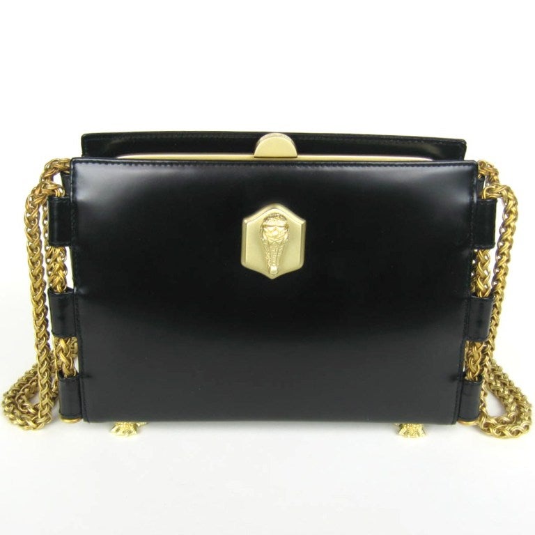 Lux Black leather Kieselstein Cord handbag. This one has a brushed gold tone metal alligator head on the front. Matte finish on Chain.  stands on four alligator feet that are hallmarked and dated 1990, lined in green suede. Comes with its dust bag.