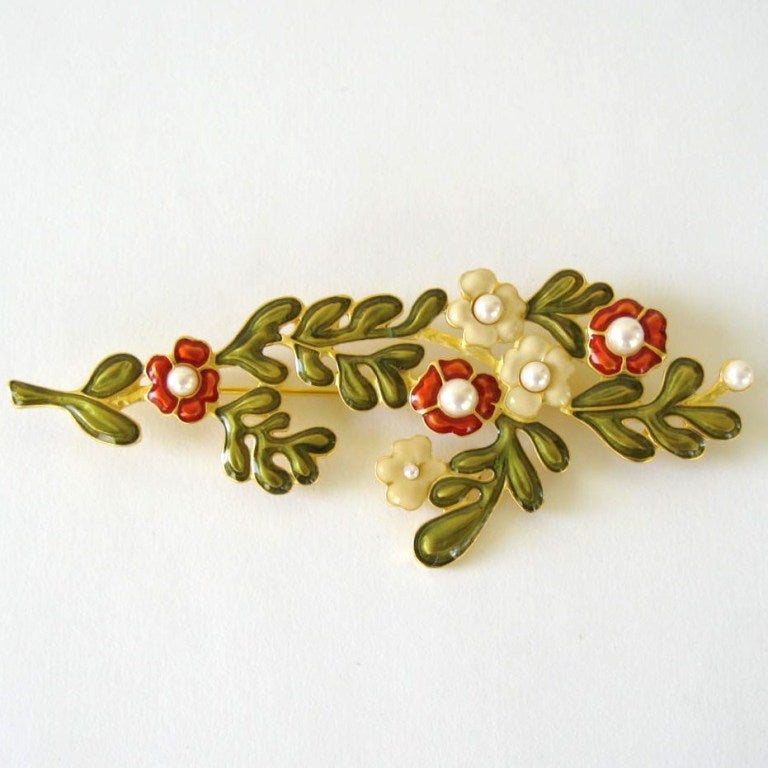 Here you have a Karl Dangerfield Enamel Pin. Enameled in Red, Green, and Tan. Pearls set inside the flowers. Simply delightful! There are several other pieces that do match this for sale as well. Measuring 3.9 In Long x 1.5 In. This is out of a