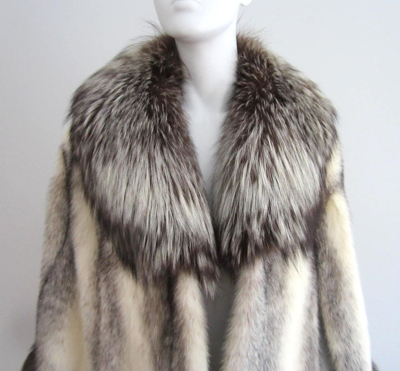 This is absolutely Fabulous. Made up of Cross Mink, soft and supple with Large Fox Collar and hem. This has pockets as well!. Brown lining, not monogrammed. Fur is soft and supple no issues. Tiny rip in the lining. We fit a range of sizes. Small -