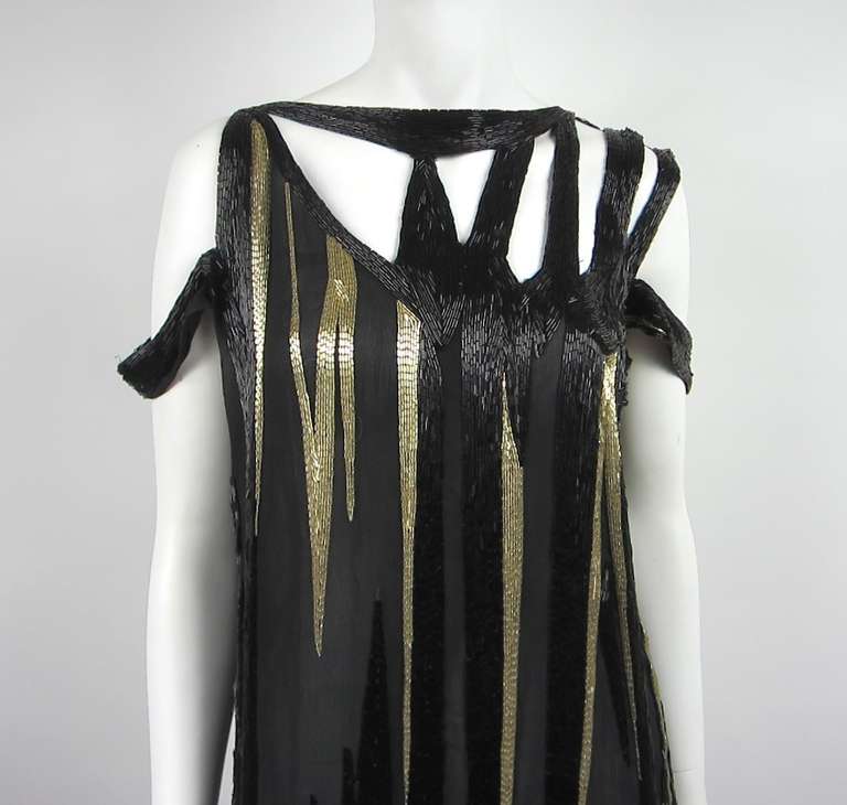 Stunning Beaded  Mackie Dress. The 1920s meets the 1980s. Black and gold beading asymmetrical Shoulders and hem. Has a Saks Label Mackie label is gone. Measures, Bust 34 Waist 34 Hips 36 Length 46 --Runway ready. New Years Eve Dream Dress! Please be
