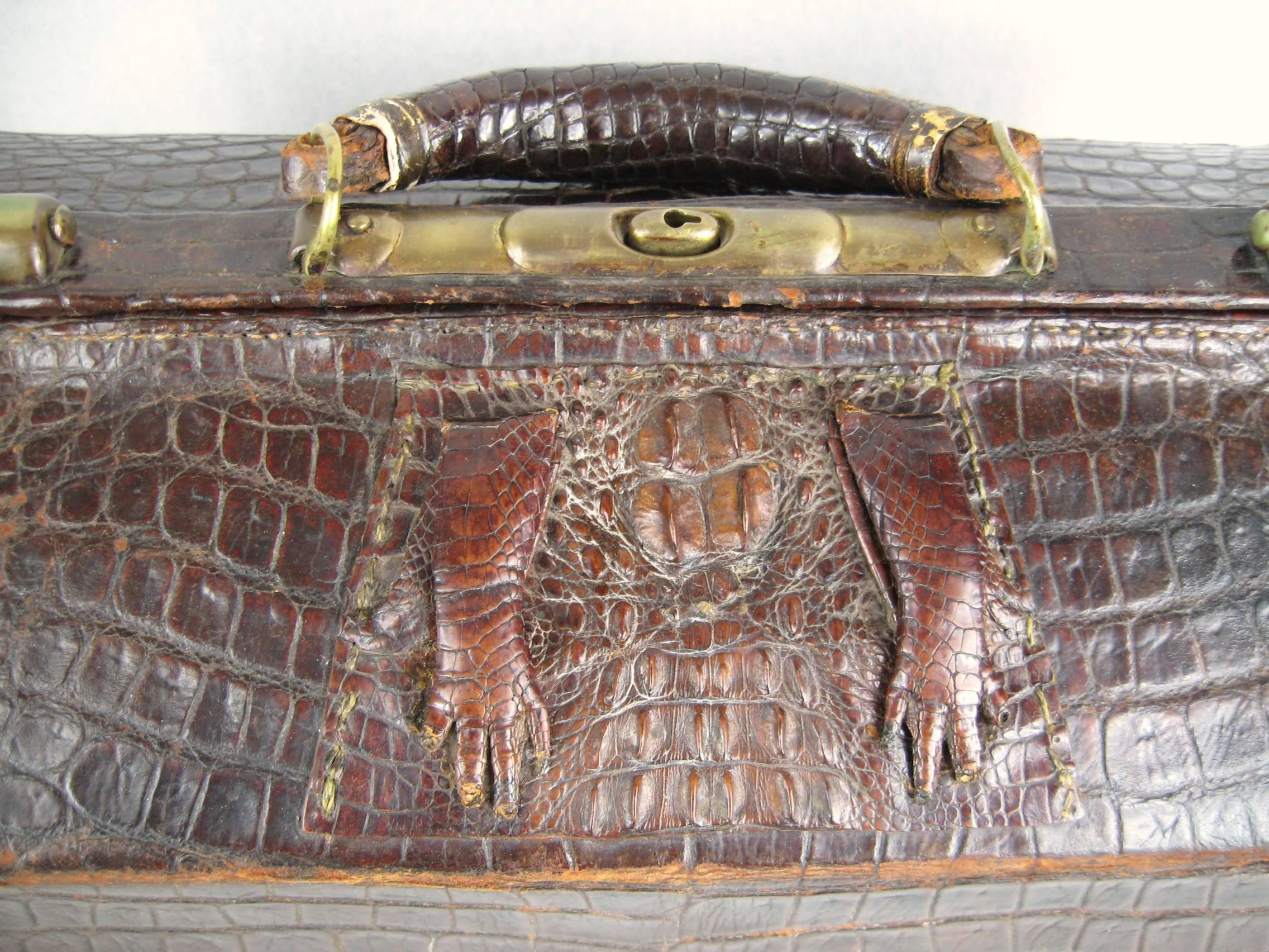 Stunning workmanship on this early Bag. Brass hardware, leather lined, baby alligator feet on the frame. Measuring 18 inches wide x 10 inches x 12 inches with handle. inside bag is 15 inches wide x 7 inches deep x 7.25 inches high. Please be sure to
