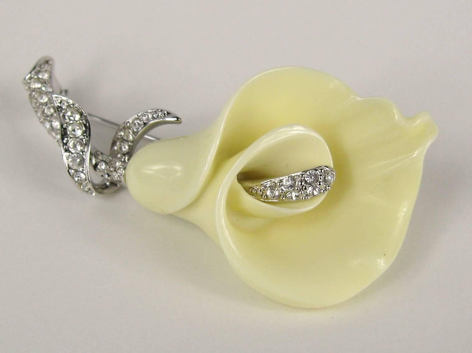 Ivory colored molded Calla Lilly, the lily has a pave crystal stamen and a pave crystal stem and leaves. Measures  2-1/2