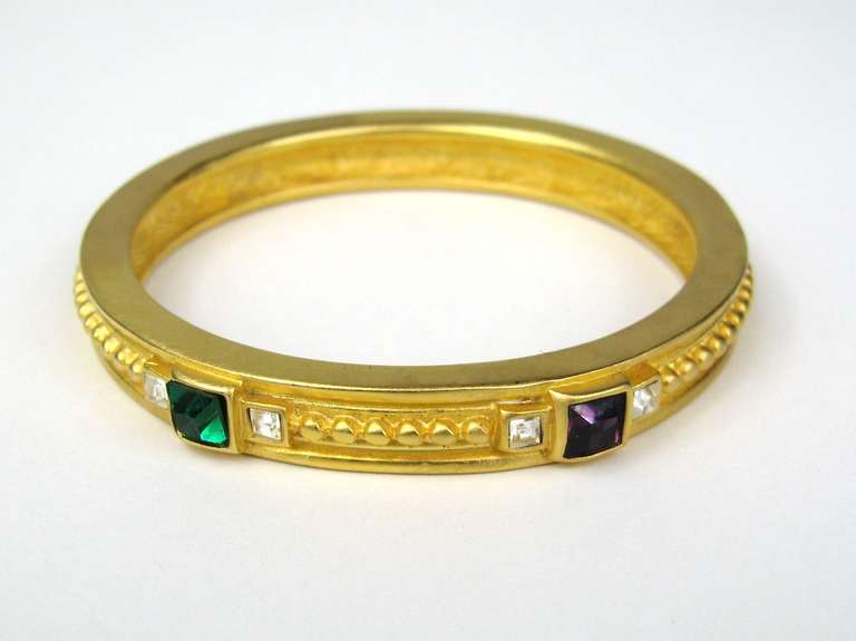 Nouveau bracelet-bracelet Givenchy des années 1990, jamais porté. Mesurant 2,50 pouces à l'intérieur et 3 pouces à l'extérieur.  Cristaux violets et verts. Ce bijou fait partie d'une collection massive de bijoux Hopi, Zuni, Navajo, du Sud-Ouest, en