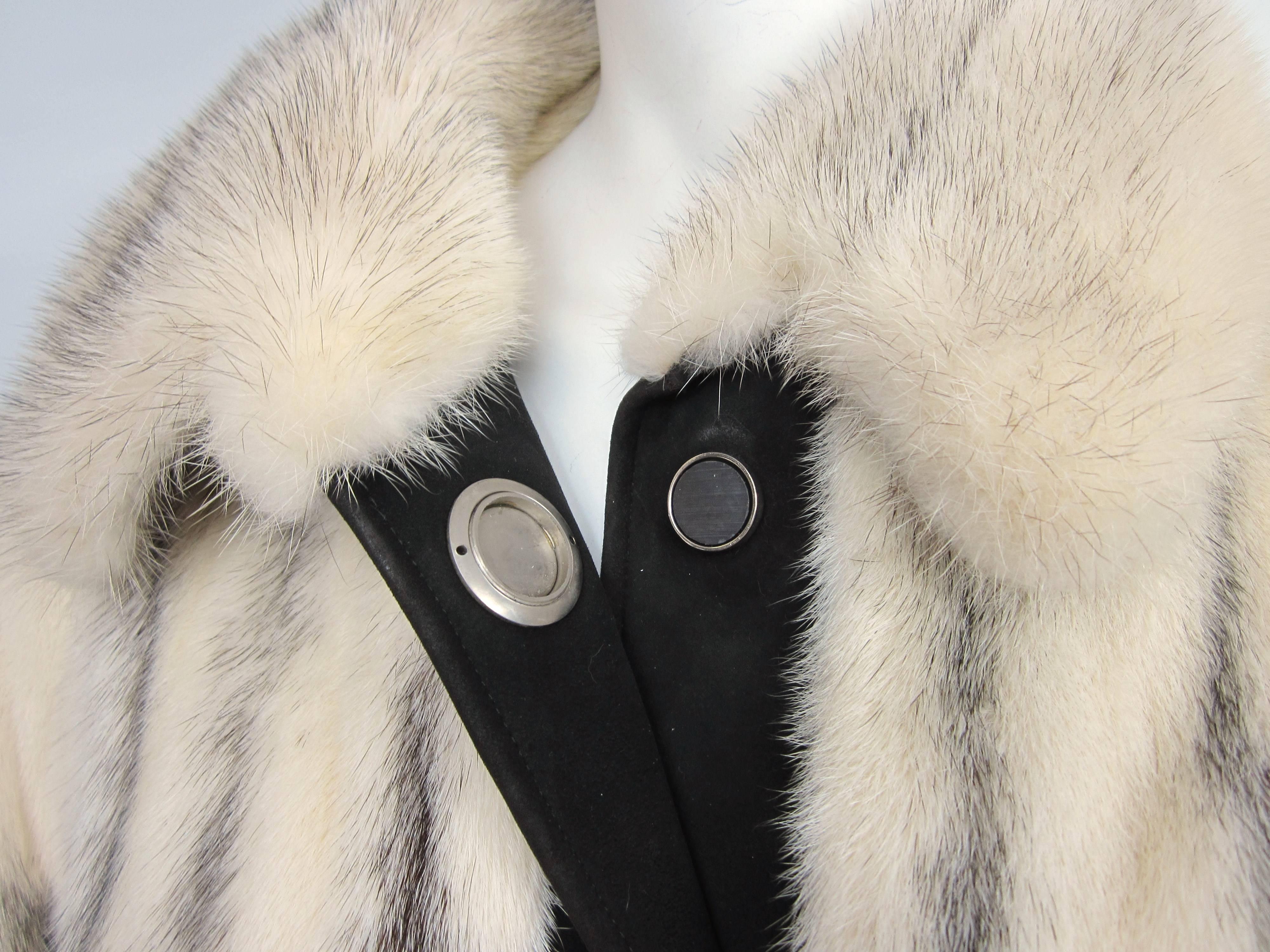 Stunning Black Cross mink Jacket with Suede accents (Cuffs, belt, and Buttons ) Magnetic Large Silver Tone Disc Buttons. Fur is soft and supple. 2 side pockets. Measures Bust up to 42 inches, Waist up to 48 in, Hips up to 50 in, length is 32 in from