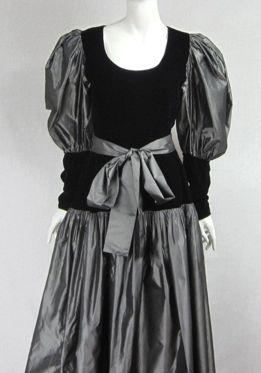 Gray and black, stunning combo in person. Large oversized balloon sleeves. Buttoned cuffs. Fitted waist dropping into a pleated silk skirt. Will fit a 8 nicely. Please be sure to check our storefront for more fashion as we have both Vintage and
