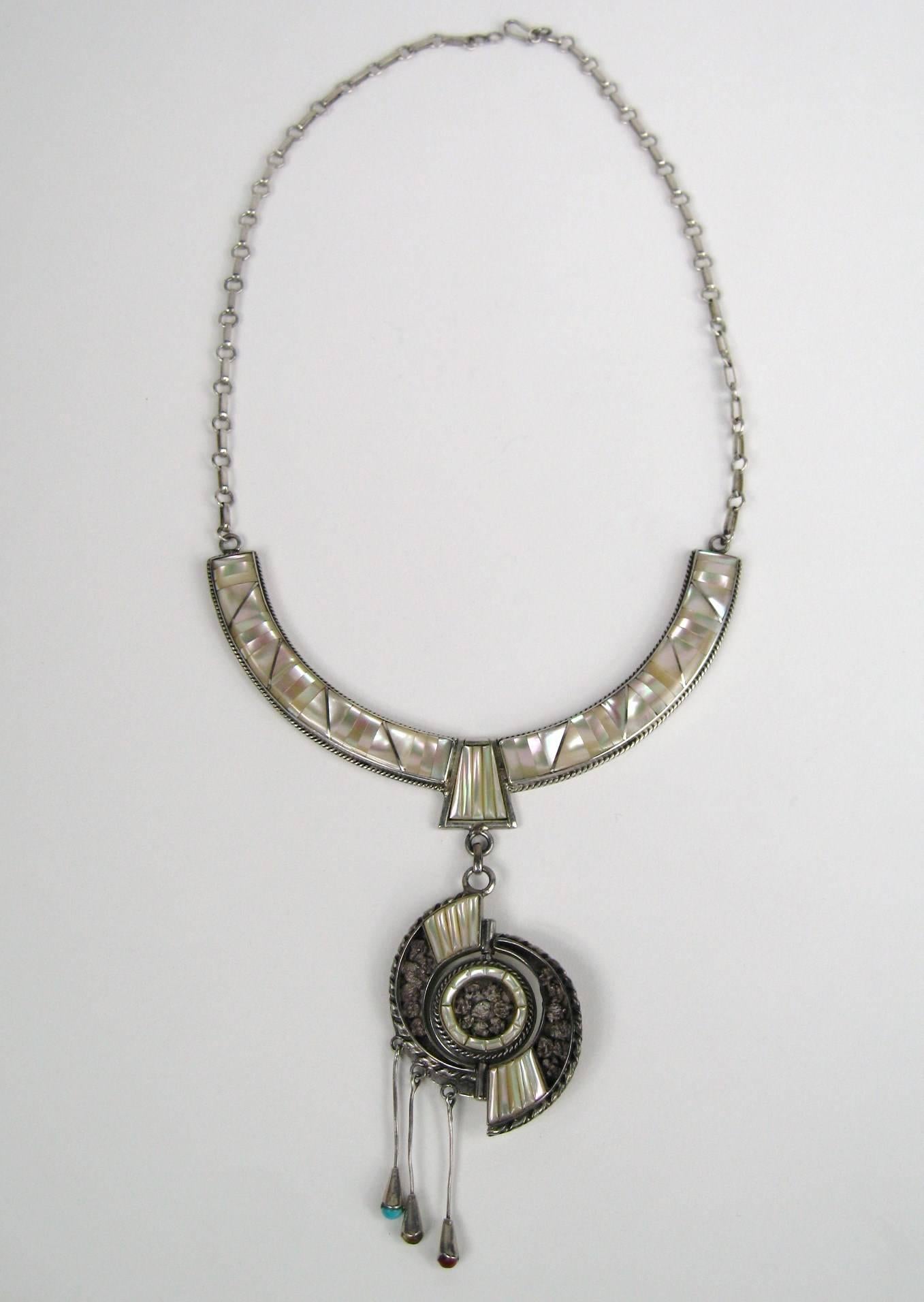 Stunning Sun Face Necklace, Coral, Turquoise and Mother of pearl set in sterling silver. 3 Dangles with stones set. This measures 26 in total drop. The Spinner is 3 in, Collar is .50 in wide. This is out of a massive collection of Hopi, Zuni,