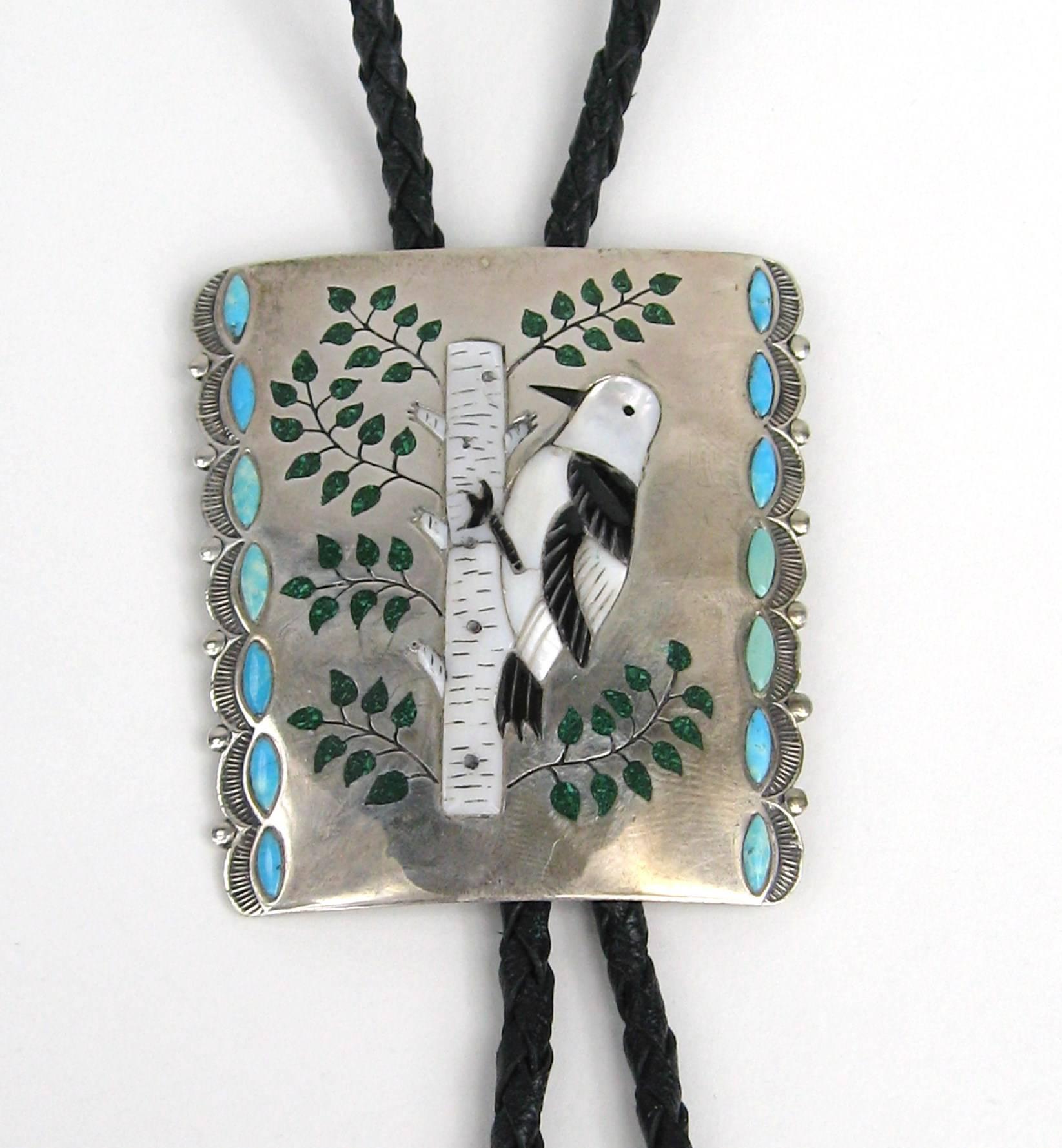 Silas Ohmsatte (1939-1990s) and Bertie Ohmsatt are the Zuni Artisans who created this fantastic bolo from Husband-and-wife team Silas and Bertise Ohmsatte worked in mosaic inlay. Measures  2.48 inches graduates down to 2.18 inches  x 2.73 inches top