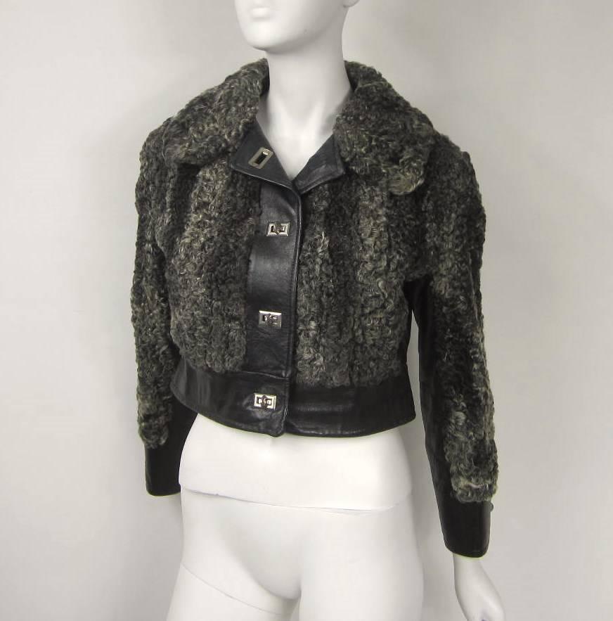 This is fabulous! You have both a Jacket and a coat. This is two jackets in one. It Zippers off at the waist. Black Detailing with Silver tone Hardware and a Funky motif lining Measuring- Chest up to 36- Waist up to 32 - Hips up to 42- Length 40