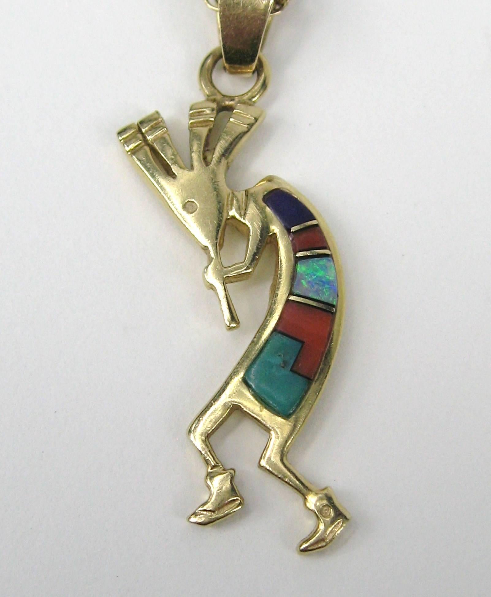 Southwestern 14k Gold Kachina. You see these a lot in silver but this one is made in 14K Gold Chain and Pendant. Inlaid stones made up the body. It measures 1.56 inches top to bottom .50 inches at the widest. Chain is 19 inches. Visit our store