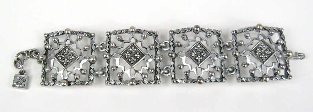 Four large studded links on this Karl Lagerfeld bracelet. Measuring 7-8.25 adjustable. We have many more pieces of New, Never worn Lagerfeld pieces on our storefront. This is out of a massive collection of Hopi, Zuni, Navajo, Southwestern, and