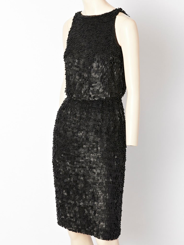 Oscar de la Renta, black pieced leather sleeveless evening dress with waist.
Dress is composed of hand stitched, tiny squares of pieced leather sewn onto a chiffon backing. The dress is very light weight.