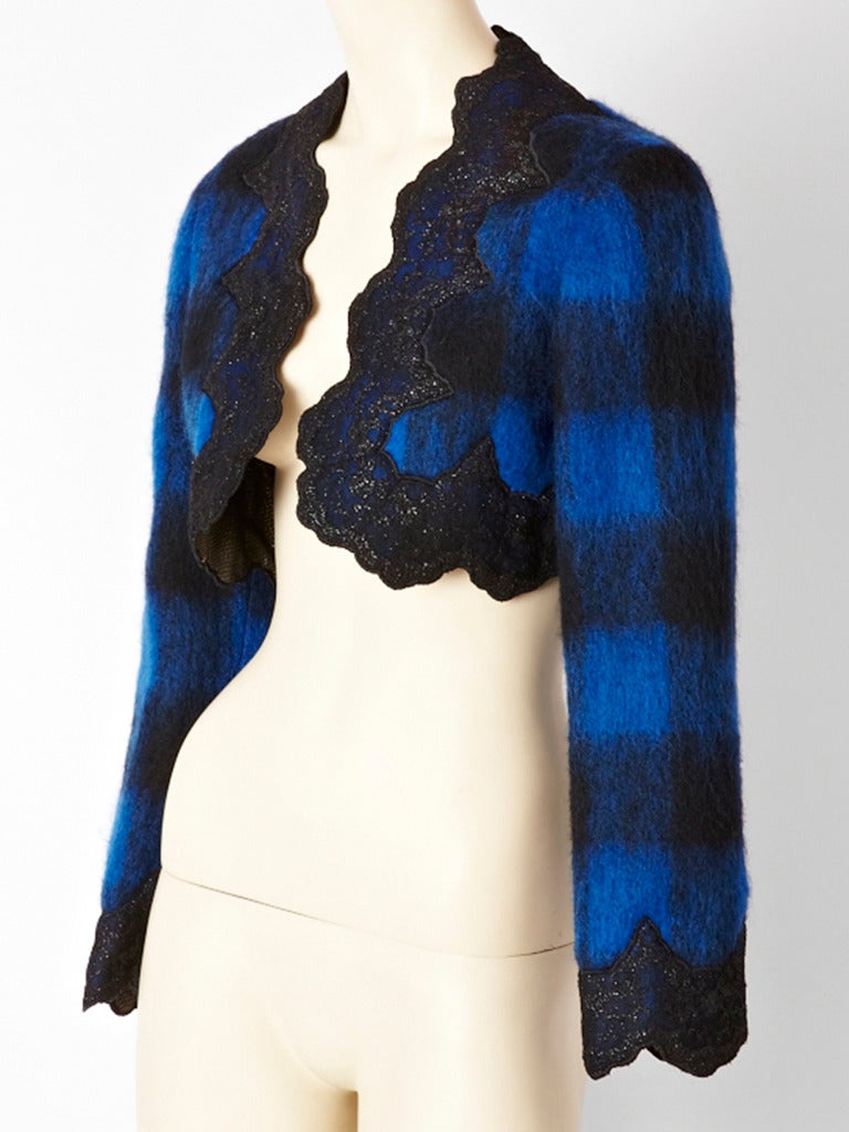 Mr. Beene, royal blue and black mohair wool bolero with applique, shimmery  wide lace border around the jacket and cuffs. Interior of bolero is silver lame.
Mr. Beene was Geoffrey Beene's, label for a younger audience.