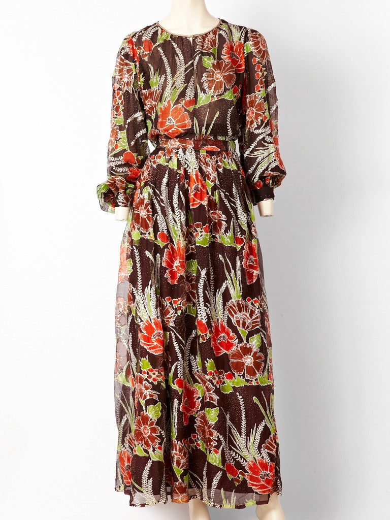 Large floral print and silver lame on chiffon 2 piece bohemian ensemble from the 70's. Top has full sleeves and an open neckline with a full, long, gathered skirt. Label reads 