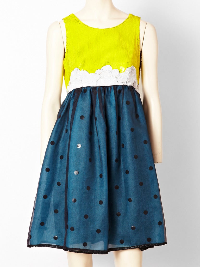 Goeffrey Beene, sequined and polka dot fantasy cocktail dress with bolero.
Bolero, has blue, yellow, and orange, flame pattern, sequins in the front and is short , fitting above the bust in the front and is longer and curved in the back. Sleeves
