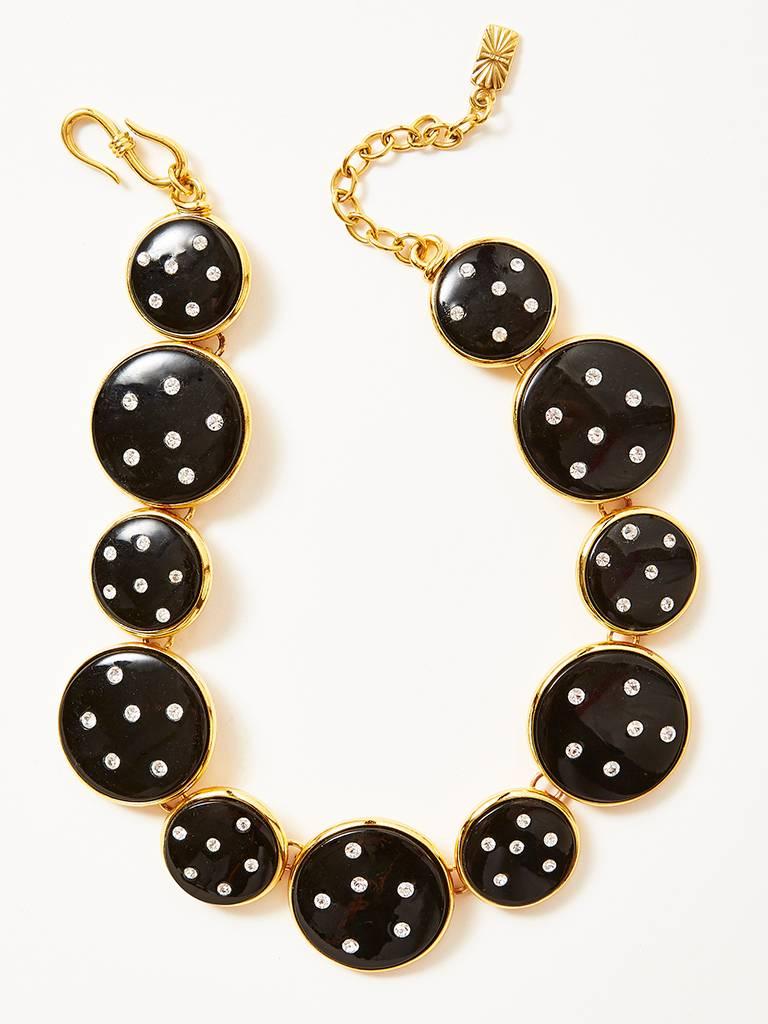 Yves Saint Laurent, necklace, of black enamel, dome shaped, circles of various sizes, embellished with rhinestones and set in gold all linked together creating a chic necklace that can be adjusted to different lengths.. C. 1990's.