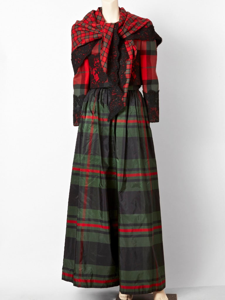 Bill Blass, red and forest green tartan plaid evening ensemble. Wool jacket is cropped with a black layer of lace on the bodice just below the bust, front and back and at the sleeve, starting at the elbow. There is a contrasting plaid taffeta, long,