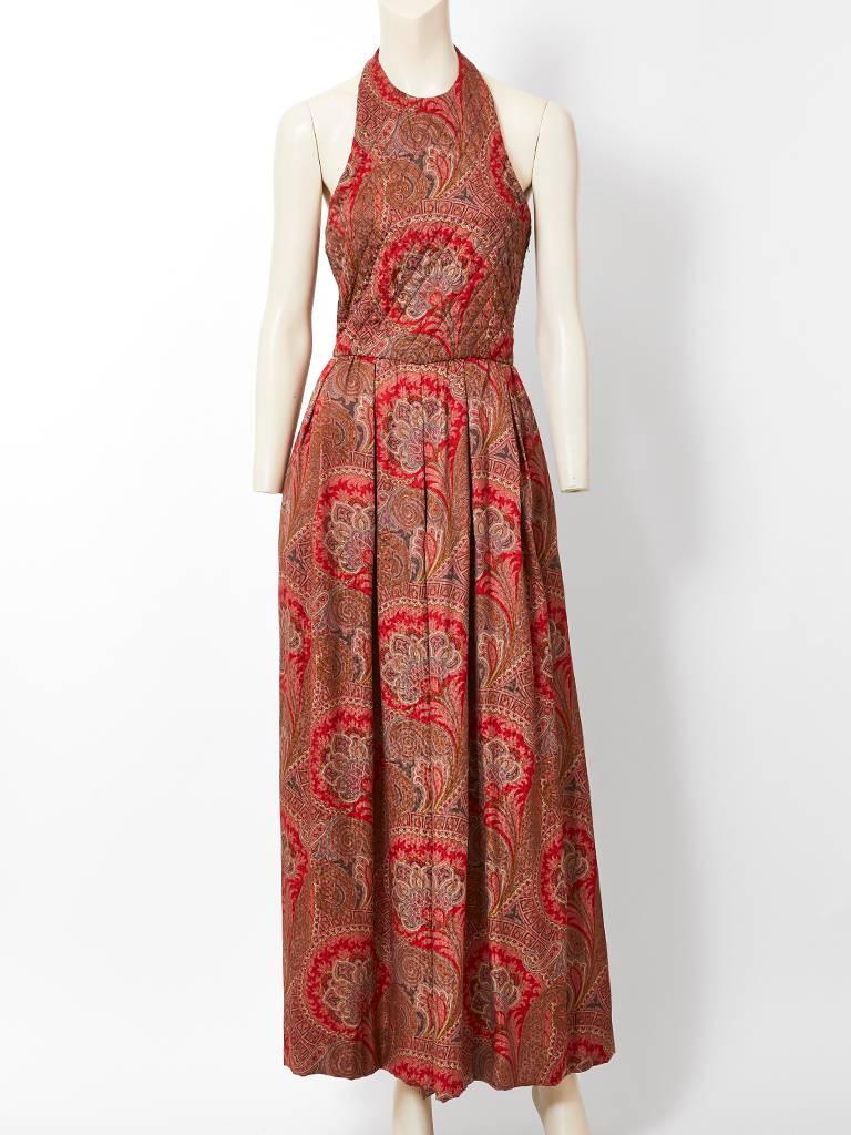 Carolyne Roehm, silk jacquard, paisley patterned halter neck jumpsuit, having and open back and a wide palazzo style pant. Bodice of the jumpsuit is quilted. There is a generous rectangular shawl of the same fabric.