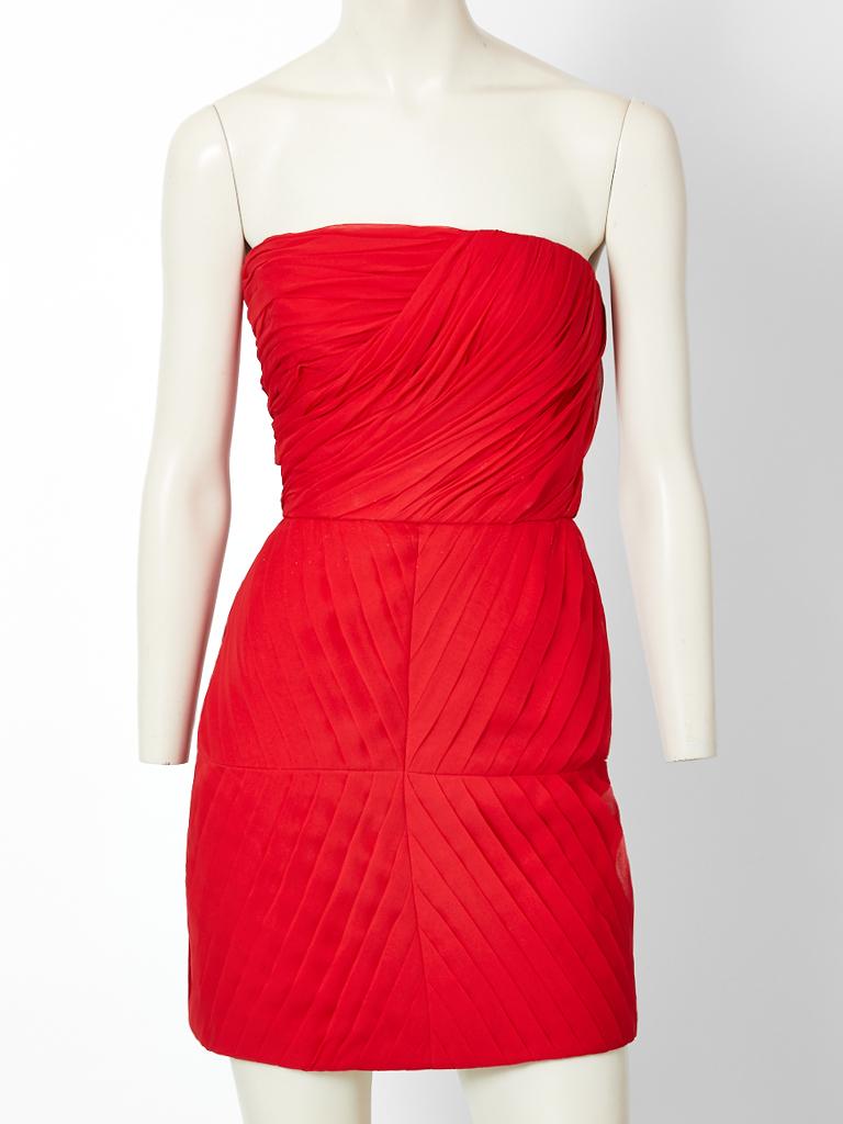 James Galanos, red, strapless, silk chiffon, short, cocktail dress, having signature Galanos,  pleating and ruching detail. Dress is accented with a dramatic gold leather belt.