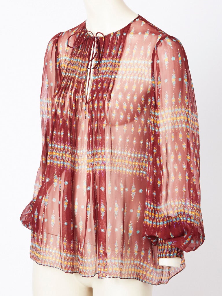 Oscar de la Renta, printed chiffon 1970's bohemian style blouse.Full cuffed 
sleeves and tie at the neck. Lovely rust shade.