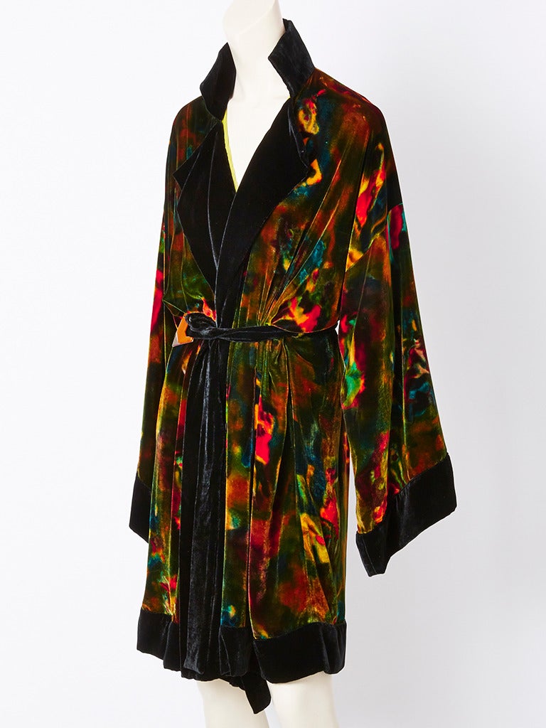 Jean Paul Gautier, colorful, printed velvet, on black ground, kimono style, belted coat. Coat has notched collar, kimono shape sleeves and is edged in black velvet. Coat is lined in a chartreuse crinkle chiffon.