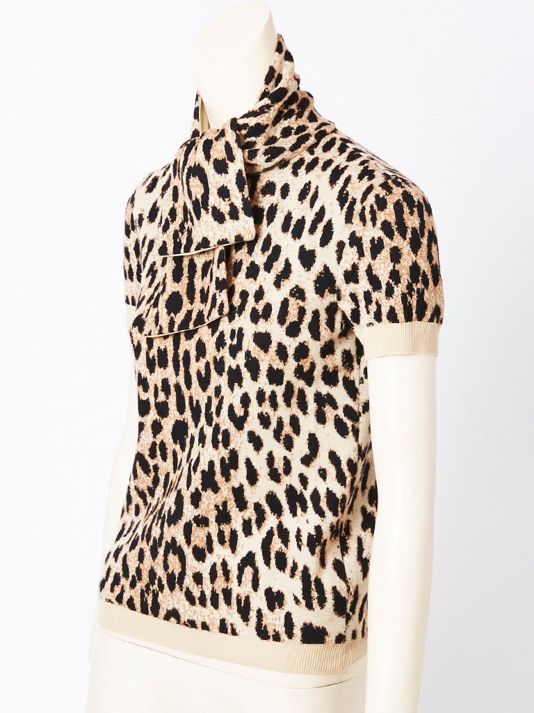Valentino, wool knit, leopard print pullover sweater with short sleeves and tie 
at the neck.