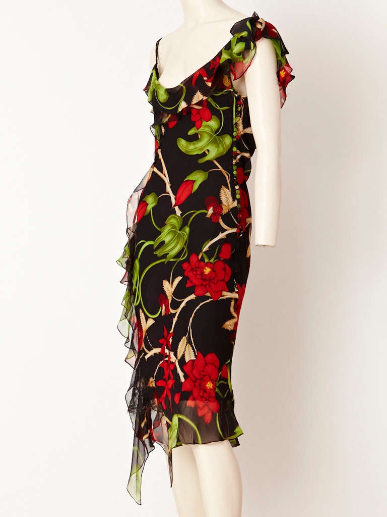 Exotic, floral print chiffon bias cut dress with an asymmetric hem and ruffle detail along the neckline and side of the dress.